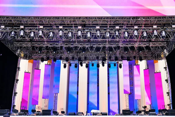 Music stage with lighting and sound equipment, large concert venue