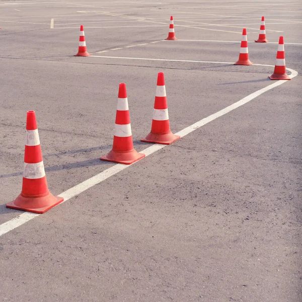 Orange traffic cones on a site in a driving school and parallel parking