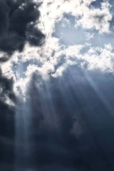 Background of black clouds with breaking sunlight