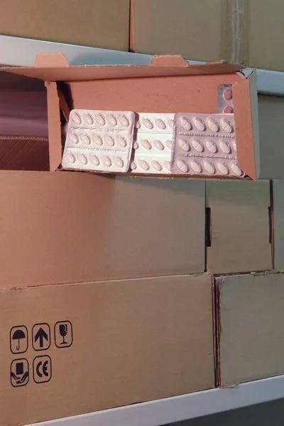 Warehouse with opened boxes of pills. Theft in a mail warehouse during quarantine due to corona virus