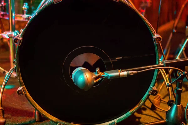 Bass drum set on red background. Percussion instruments at a jazz concert. Drum and plates are on the stage of the concert hall