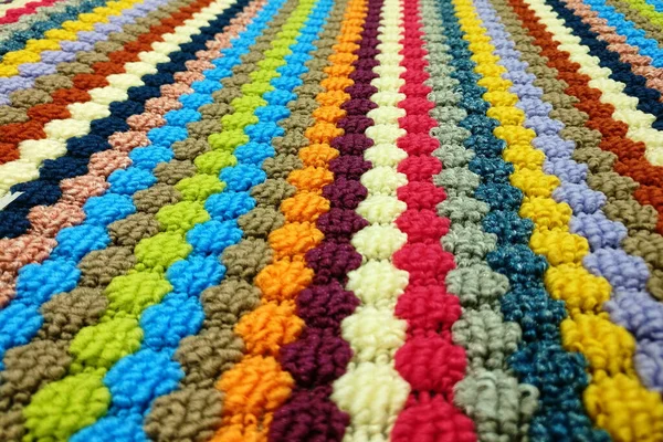 Texture of knitted multicolored wool carpet