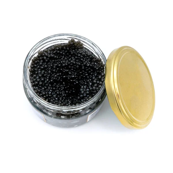 Imitation caviar in a glass jar with a lid. Synthetic food fake fish eggs. White isolated background. Glass jar with imitation black caviar sturgeon. — Stock Image Imitation Caviar Glass Jar Lid Synthetic Food Fake Fish Eggs Stock Picture