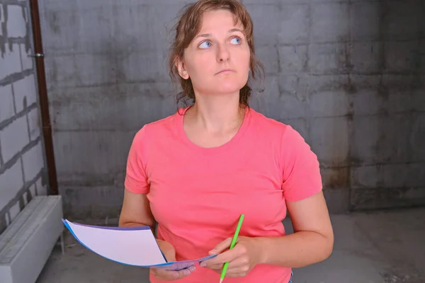 Inspection of the newly built house. Check the engineer of the project of the new apartment . A woman designer evaluates an flat in a new house.