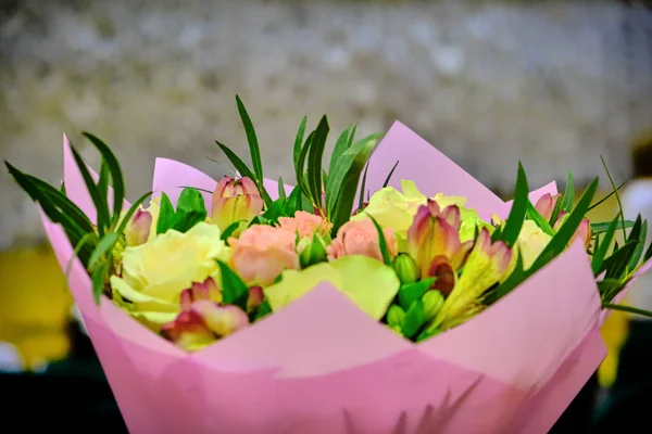 Bouquet of roses in the concert hall. Bouquet of flowers to congratulate the singers. Beautiful flowers for the singer on stage.