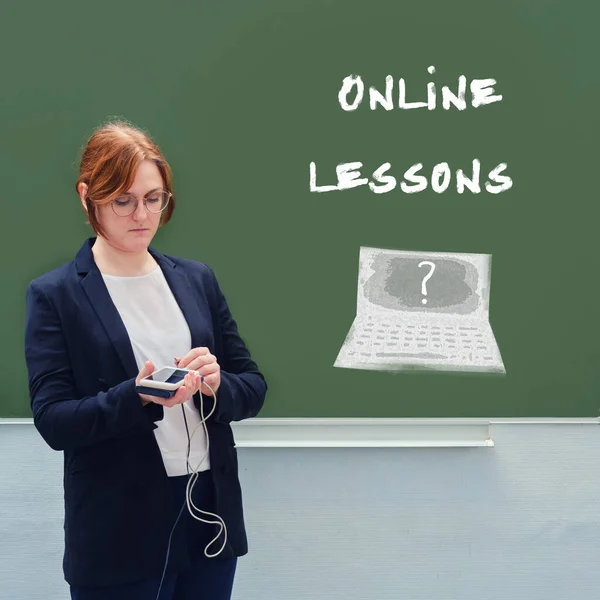 Concept problems with distance education. School teacher and the text online lessons written on the blackboard
