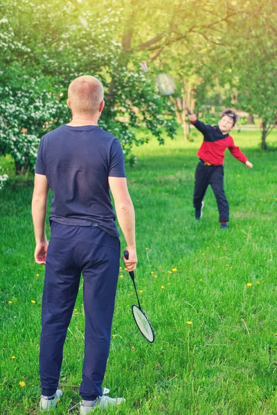 Father and son are engaged in playing sports during outdoor recreation