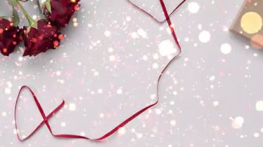 Romantik bir Sevgililer Günü kutlama animasyonu. Kırmızı güllerle dolu kalp şeklinde bir kutu, renkli konfeti parçalarından oluşan canlı bir patlamayla bir masanın üzerinde duruyor. Sevgi, neşe ve şenlik için mükemmel..