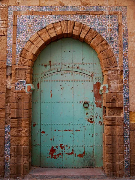 Traditional, green-painted Door with tiles, Morocco. High quality photo