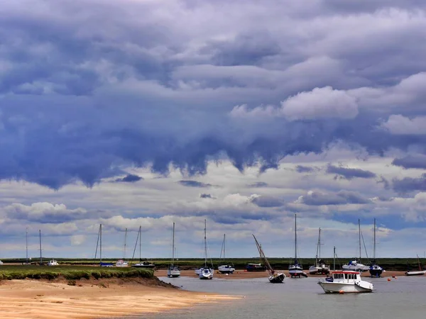 Big skies and boats in Blakeney, North Norfolk coast, East Anglia, UK. Ample copy space. High quality photo