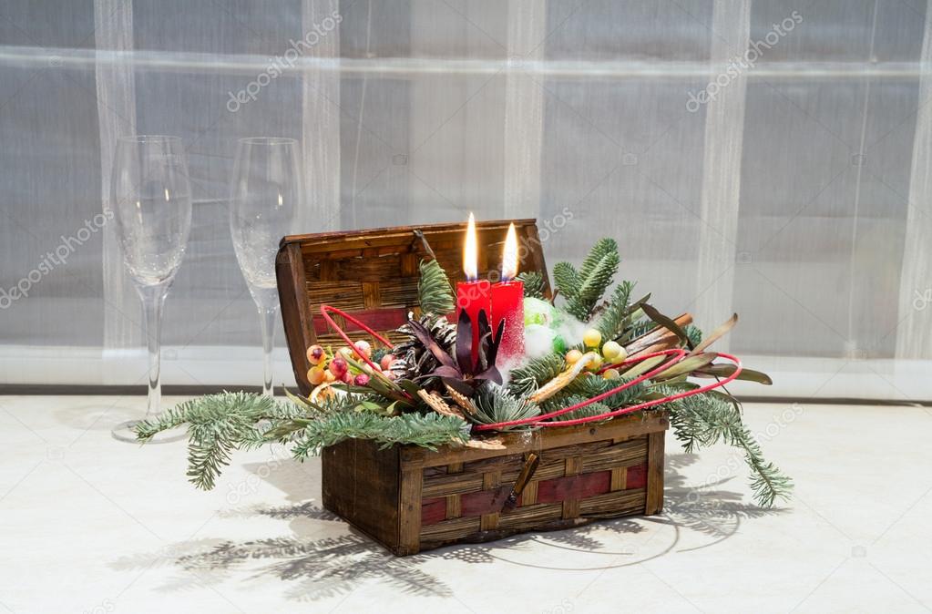 Christamas decoration for house: wooden box with candles, Christamas tree, flowers and two wine glasses