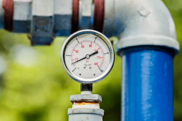 Water pressure meter installed on a blue pipe — Stock Photo, Image