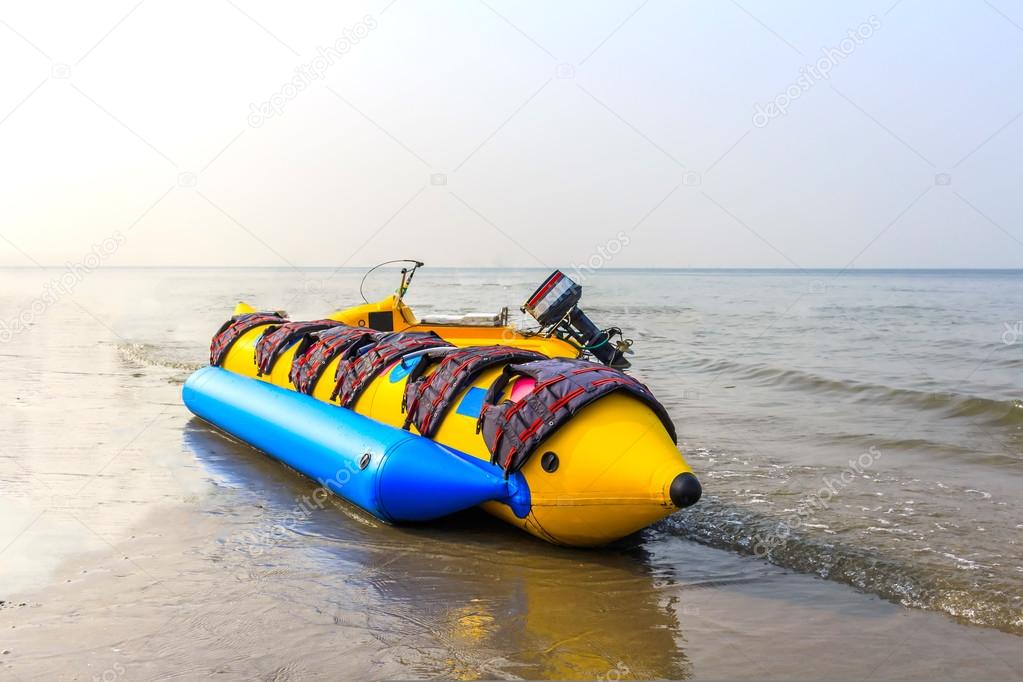 banana boat lays on a beach