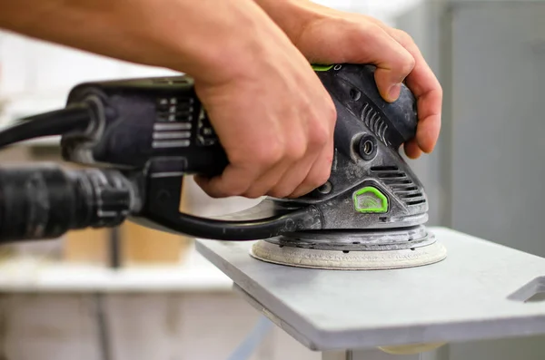A carpenter works on wood in a carpentry workshop. Grinding tools — Stock Image A carpenter works on wood in a carpentry workshop. Grinding tools Royalty Free Stock Images
