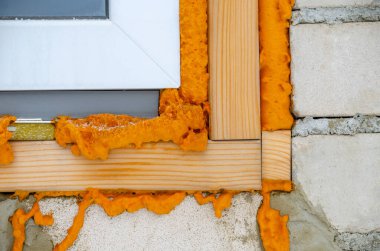 Construction foam. Foam of a stroiteln at a window. Dry foam at a window clipart