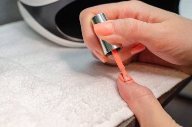 Manikürü kadının kendisi yapıyor. Manikür aletleriyle kadın elleri. Çivi bakımı kavramı