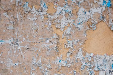 Eski ilan tahtası. Yırtık ilan panosu yatay olarak asılmış eski bir sokak afişi. Açık hava duyuru panosu veya yıpranmış reklam mesajı içeren kontrplak paneli