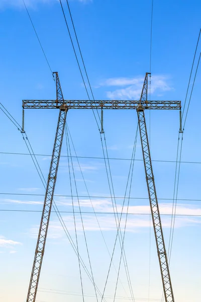 High voltage pillar. Power grid pole against the sky. High voltage tower. Electricity use and electricity cost concept