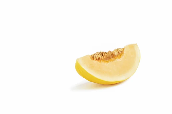 Melon on a white background. Yellow melon on a white isolate. Fresh juicy piece of melon with shadow on a white background. For insertion into a project, design or advertisement — Stock Photo, Image