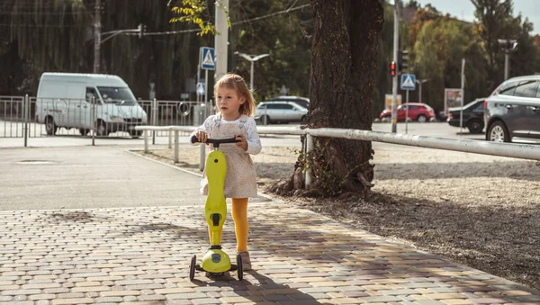 Pequena Menina Caucasiana Monta Uma Scooter Uma Cidade Cheia Obstáculos — Fotografia de Stock