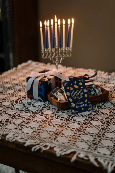 hanukkah candle and gifts on the table