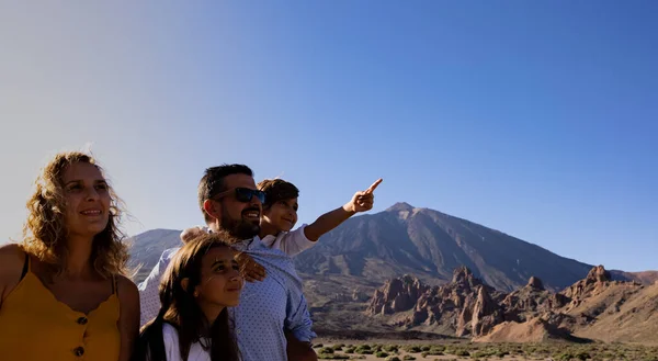 tourism family in tenerife watching the teide