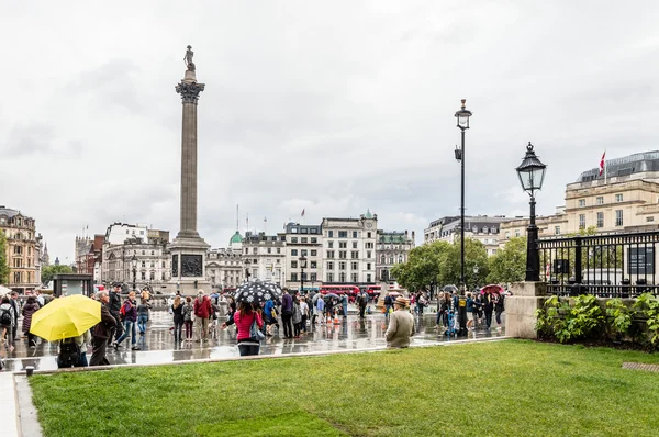 Crowd in Trafalgar square a rainy day