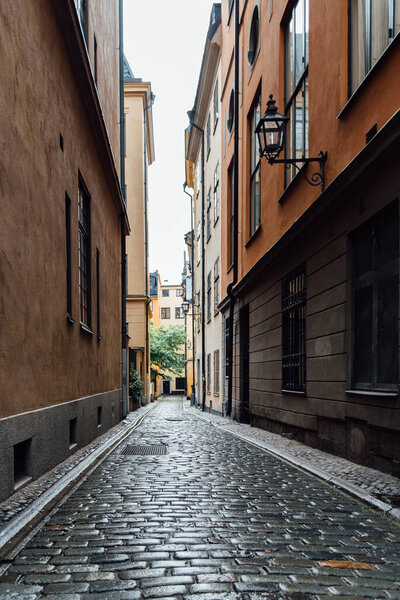 Beautiful old cobblestoned street amidst old colorful houses in Gamla Stan in Stockholm.