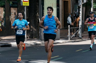 Madrid maratonu boyunca tüm çabalarıyla koşan bir grup koşucu