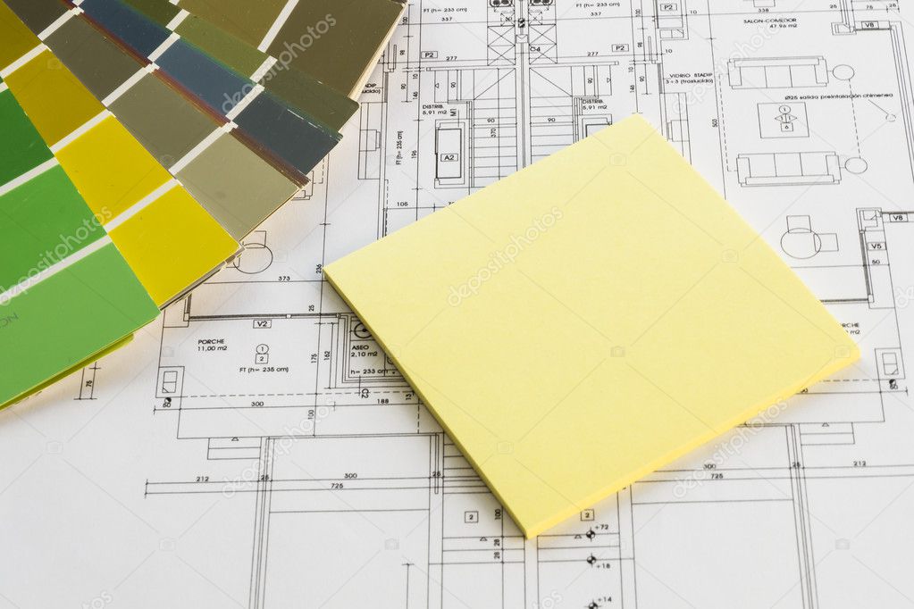 Architect workplace with a plan, color tables and postit