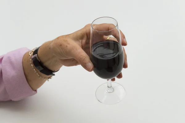 Old woman hand holding a glass of wine — Stock Photo, Image