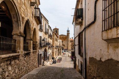 Trujillo, Spain - October 18, 2022: A picturesque street in Trujillo, Extremadura, Spain, featuring historical architecture and a view towards a church.