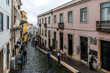 Lisbon, Portugal - October 29, 2022: A picturesque street in Alfama, Lisbon, with traditional architecture,and vibrant colors a rainy day