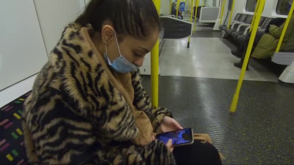 Young Woman Wearing Face Mask Faux Fur Coat Train Checking — Stock Video