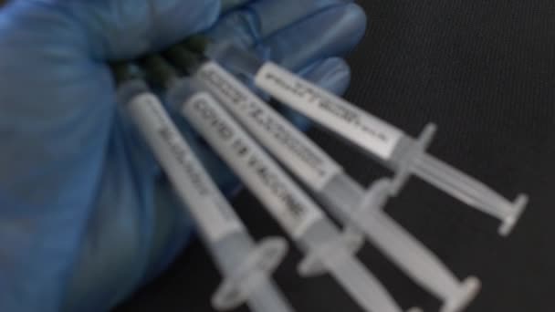 Covid Vaccine Syringes Held Blue Gloved Hand Rack Focus Locked — Stock video