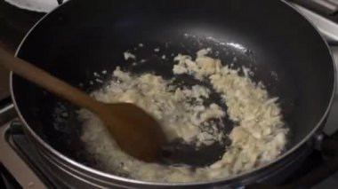 Tahta kaşık çıtırdıyor, yağda kızartılmış tavada sarımsak eziliyor. Kilitli 