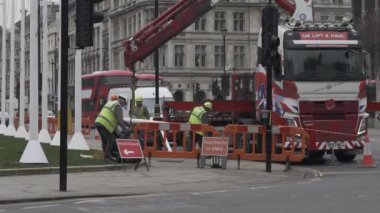 Workers Clearing Up Rubbish Beside Knuckle Boom Crane Lorry At Parliament Square. Locked Off 