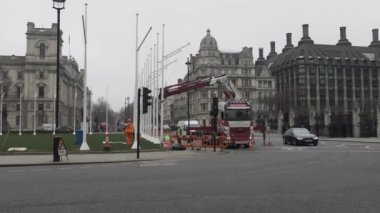 Workers Installing Flagpole In Parliament Square Gardens With Traffic Going Past. Locked Off