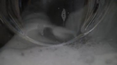 Close Up Of Empty Spin Wash Cycle With Foam And Water In Washing Machine. Locked Off