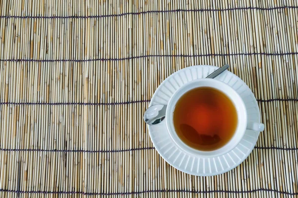 El té blanco de la taza en la estera de madera —  Fotos de Stock