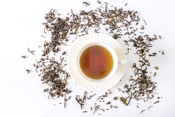 White tea cup with tea and tea leaf — Stock Photo, Image