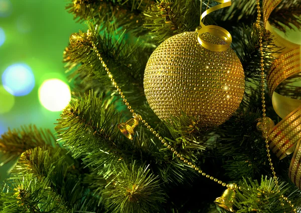 Golden ball on the Christmas tree branch — Stock Photo, Image