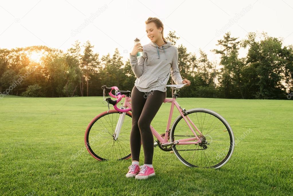 Woman quenches thirst after riding a bike