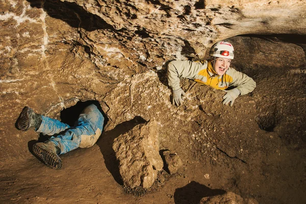 Une jeune fille coincée dans un trou de grotte — Photo