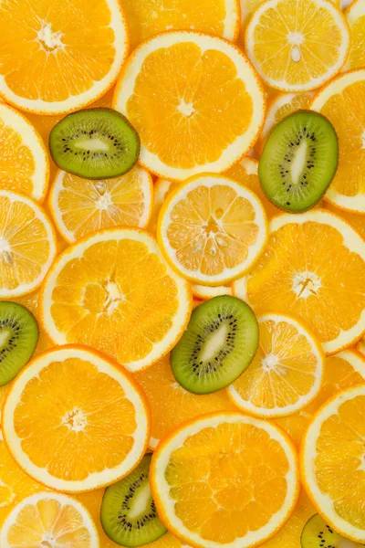 Sliced healthy fruits background — Stock Photo, Image