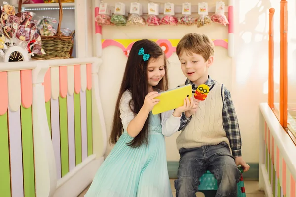 Happy kids looking at the tablet — Stock Photo, Image