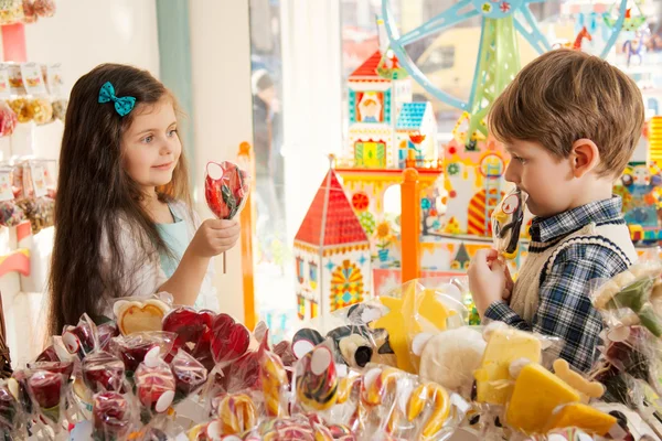 Happy children in a candy store — Stock Photo, Image