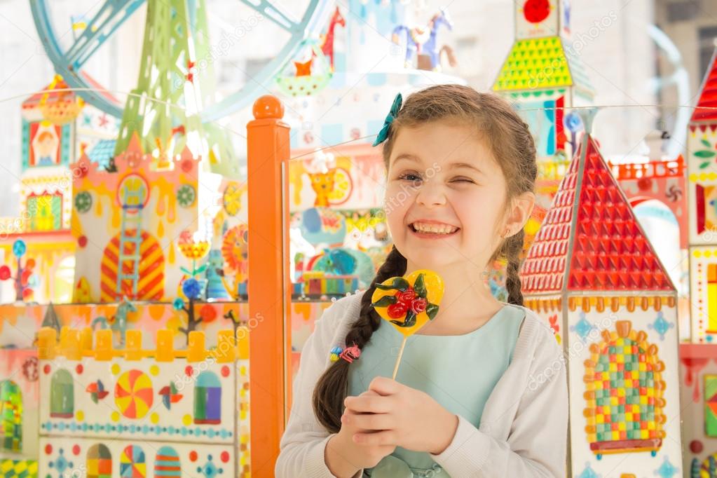 Beautiful hamming girl with lollipop in hands