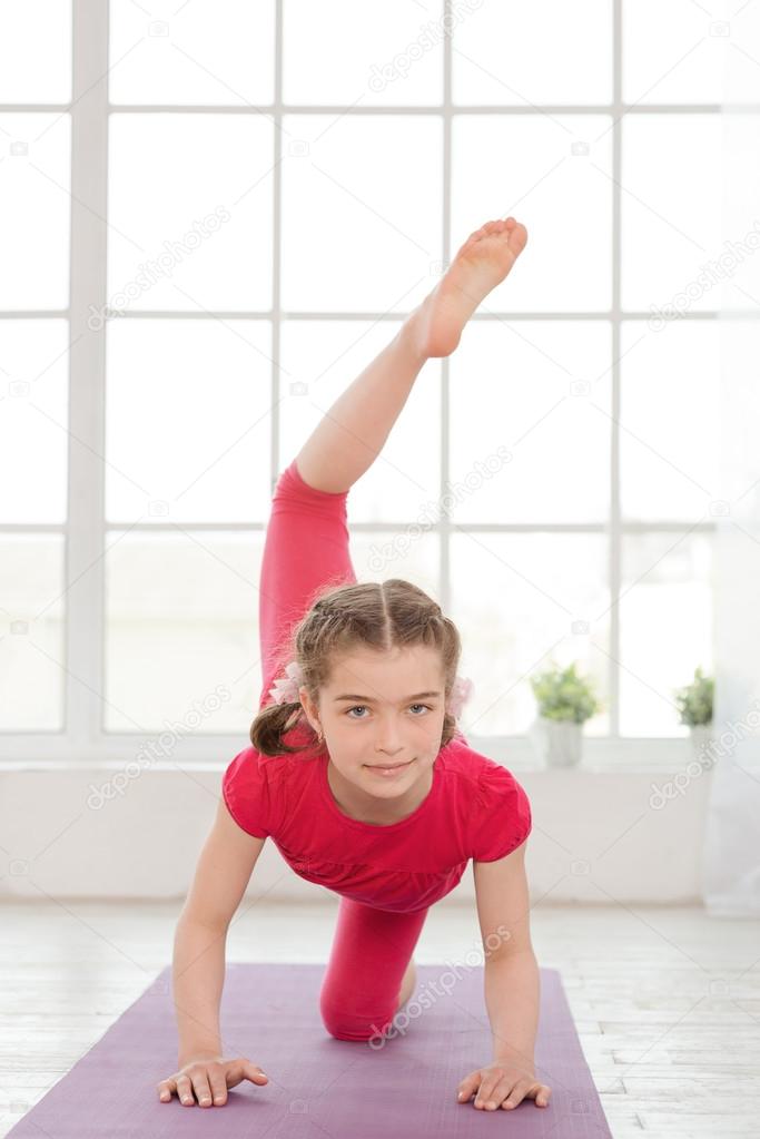 Little girl doing yoga exercise
