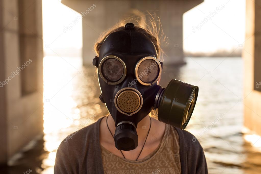 Ecological concept of air contamination. Woman in gas mask